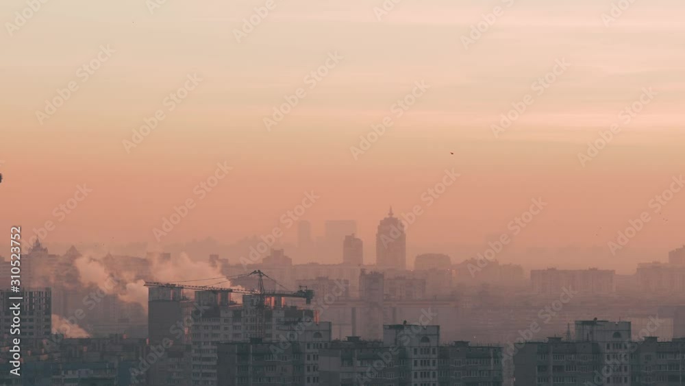City landscape with high-rise residential apartments on a winter evening. The sleeping area of the metropolis. Panorama of the capital of Ukraine, Kiev. Urbanization. Cranes at a building site City landscape with high-rise residential apartments on a winter evening. The sleeping area of the metropolis. Panorama of the capital of Ukraine, Kiev. Urbanization. Cranes at a building site