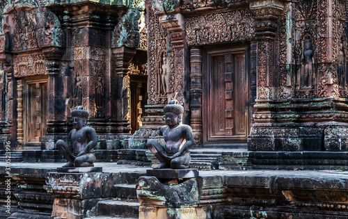 detailed carvings pink limestone walls of Banteay Srei temple Cambodia