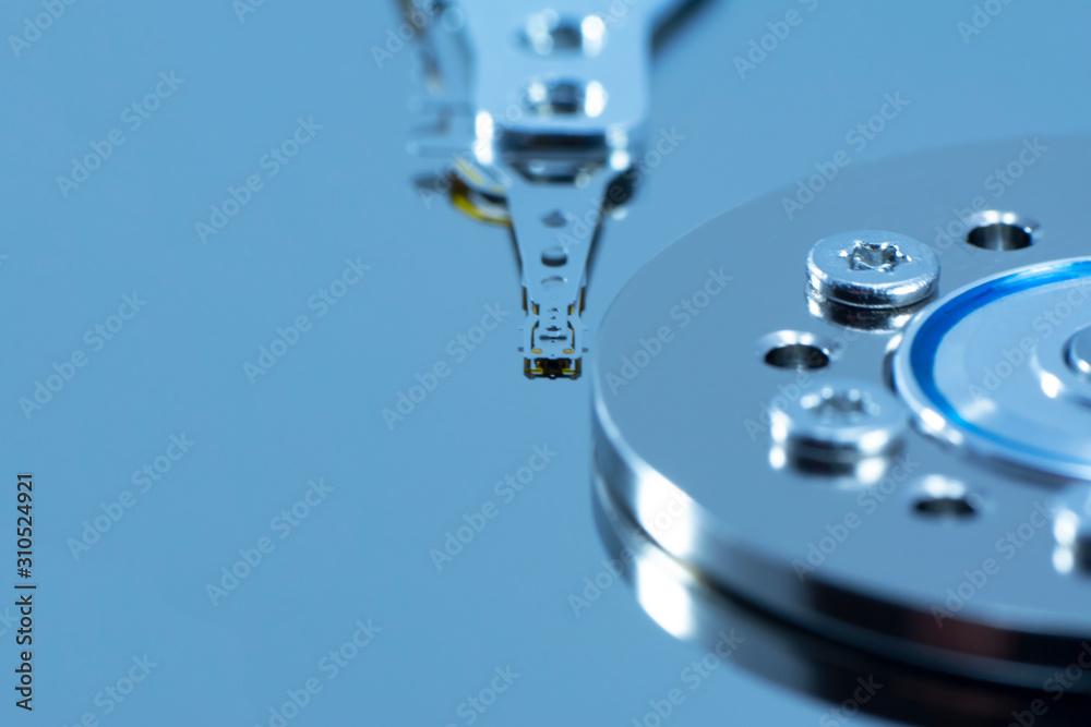Disassembled hard drive from the computer, hdd with mirror effect. Opened hard drive from the computer hdd disk drive with mirror effects. Part of computer pc, laptop. Disassembled hard drive from the computer, hdd with mirror effect. Opened hard drive from the computer hdd disk drive with mirror effects. Part of computer pc, laptop.