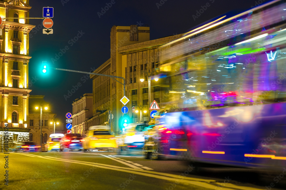 blurred image of a bus traveling in Moscow at night