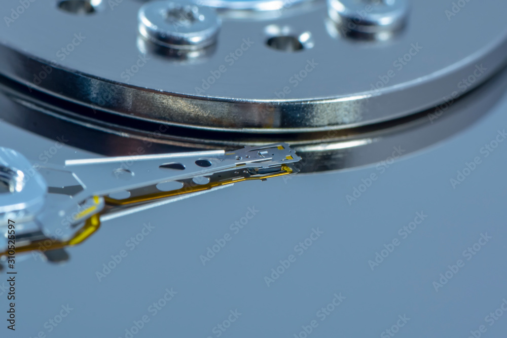Disassembled hard drive from the computer, hdd with mirror effect. Opened hard drive from the computer hdd disk drive with mirror effects. Part of computer pc, laptop. Disassembled hard drive from the computer, hdd with mirror effect. Opened hard drive from the computer hdd disk drive with mirror effects. Part of computer pc, laptop.