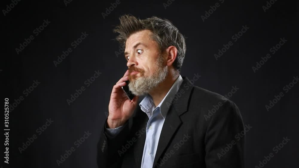 businessman or worker in black suit with beard calling with his phone. get good new or win businessman or worker in black suit with beard calling with his phone. get good new or win