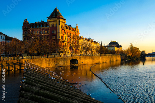 image of the embankment of the Vltava river in Prague at sunset