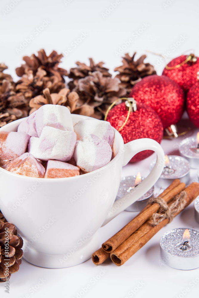 Cup of hot chocolate with marshmallows, and some cinnamon sticks, cones, christmas balls and candles Cup of hot chocolate with marshmallows, and some cinnamon sticks, cones, christmas balls and candles
