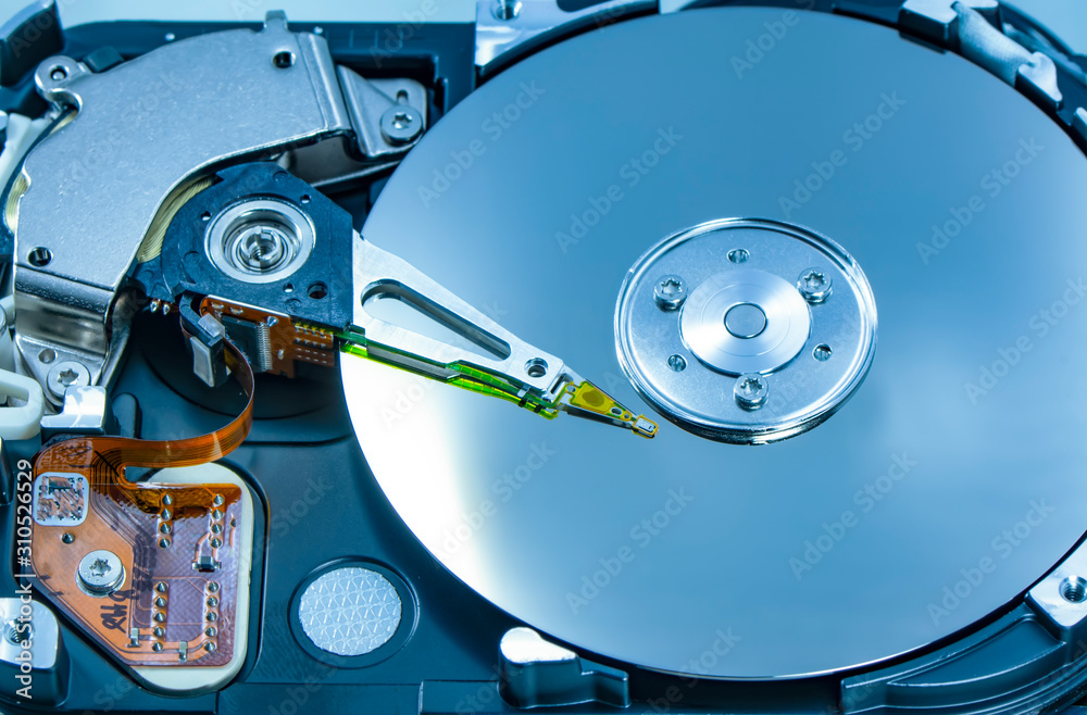 Disassembled hard drive from the computer, hdd with mirror effect. Opened hard drive from the computer hdd disk drive with mirror effects. Part of computer pc, laptop. Disassembled hard drive from the computer, hdd with mirror effect. Opened hard drive from the computer hdd disk drive with mirror effects. Part of computer pc, laptop.