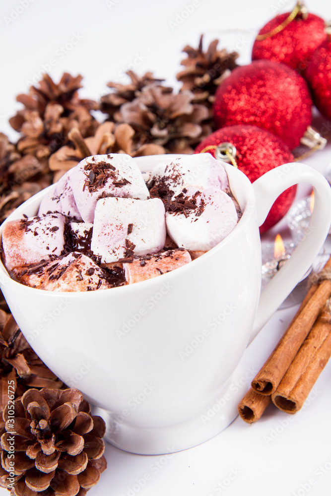 Cup of hot chocolate with marshmallows, and some cinnamon sticks, cones, christmas balls and candles Cup of hot chocolate with marshmallows, and some cinnamon sticks, cones, christmas balls and candles