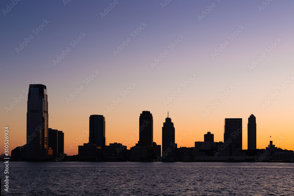 City skyline during a beautiful colorful sunset - New Jersey from New york