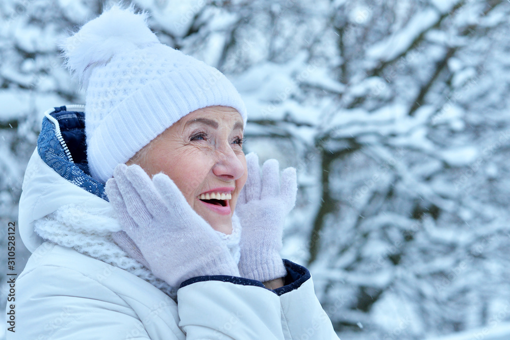 Portrait of happy beautiful senior woman in warm hat Portrait of happy beautiful senior woman in warm hat