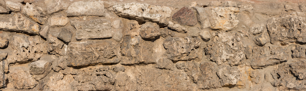 Stone brown wall, old medieval castle Stone brown wall, old medieval castle