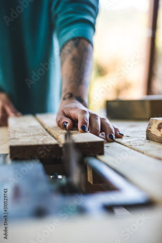 A woman works in a carpentry workshop.