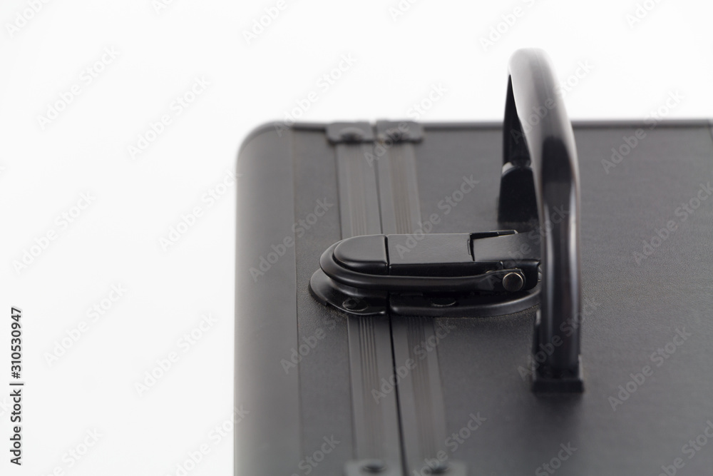 Lock and handle of black business suitcase, closeup, shallow depth of field