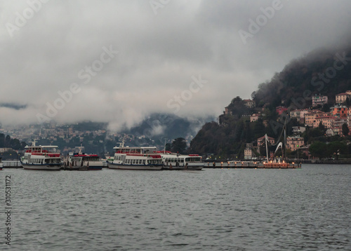 winter panorama on the Como lake with low clouds enveloping the mountains © gpriccardi