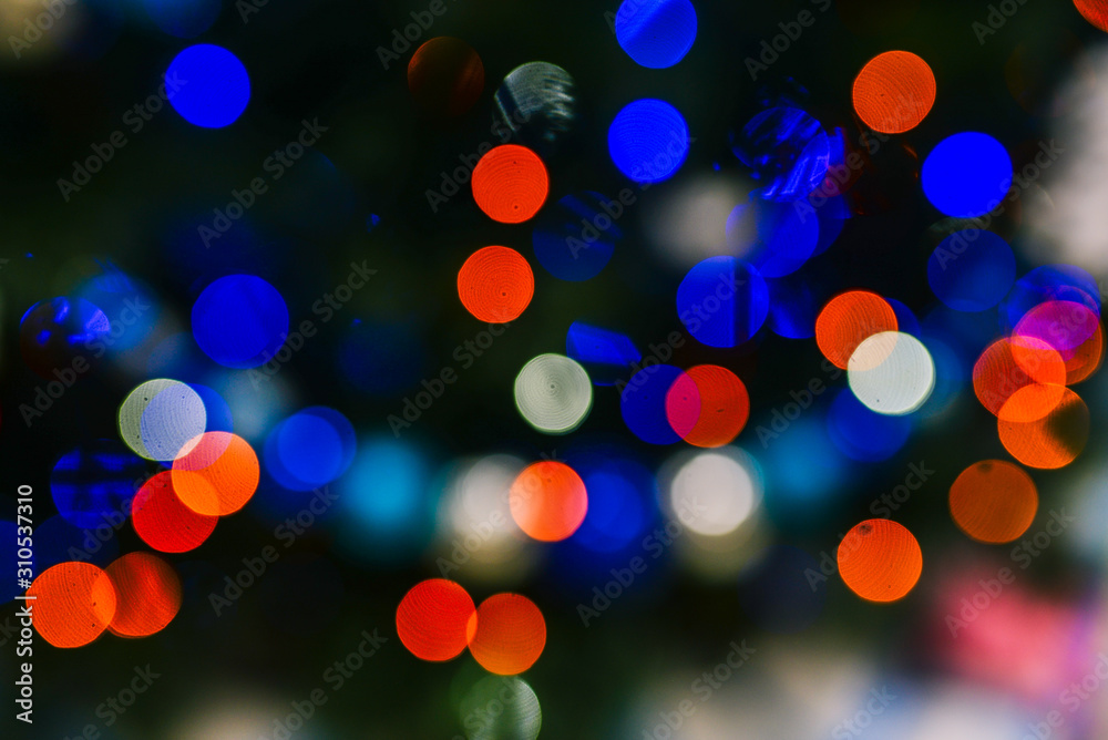 Blue, red and white holiday bokeh. Christmas background. Bright and abstract blurred colorful background with shimmering glitter Blue, red and white holiday bokeh. Christmas background. Bright and abstract blurred colorful background with shimmering glitter