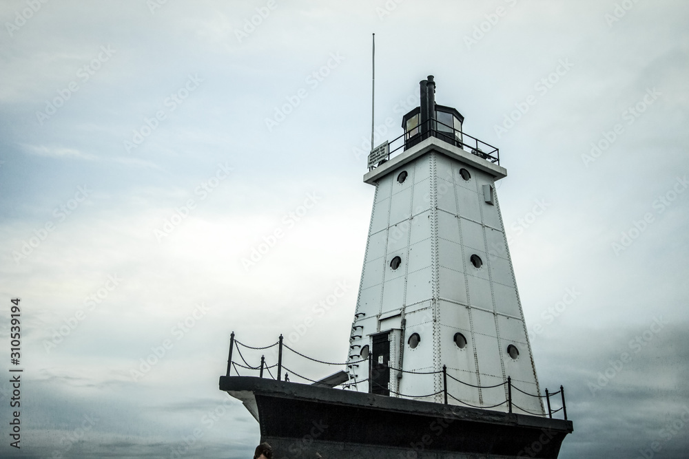 Lighthouse Background. The Ludington Lighthouse is an active navigational beacon on the coast of Lake Michigan.