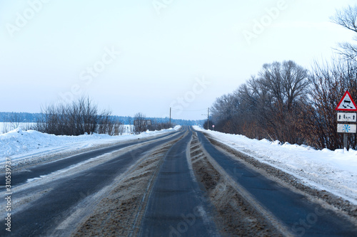 Winter poorly cleared road. Road in the countryside strewn with snow. Snowdrifts © Kate