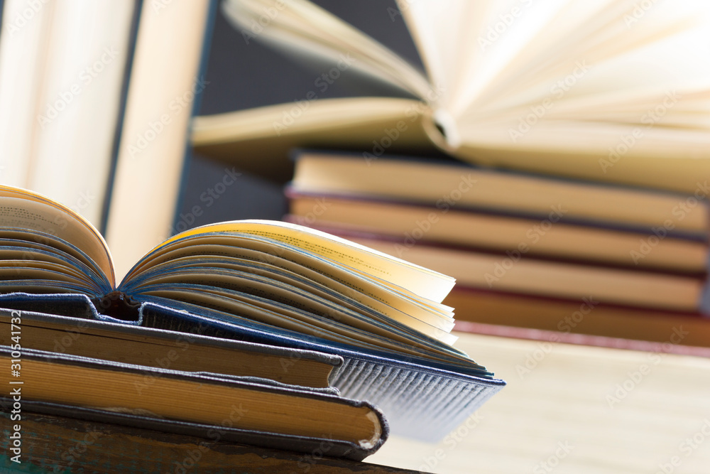 Naklejka premium Open book, hardback books on wooden table. Back to school. Copy space