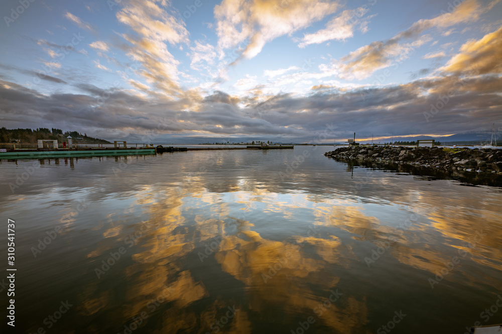 Reflection of the morning sunrise in the calm Comox harbor