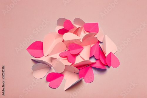 Love (Valentine's day) background or wedding background. Pink and red paper hearts on a blue pastel background. Love concept