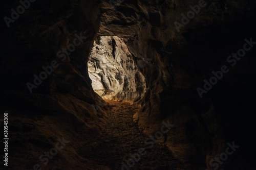 View out of a cave. Dark photo of an entrance or exit from a cave.