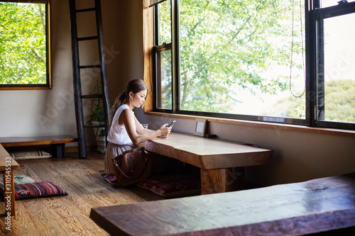 Japanese woman sitting at a table in a Japanese restaurant. photo