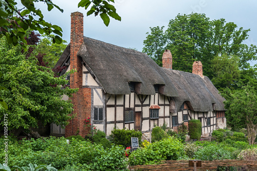 STRATFORD UPON AVON, ENGLAND - MAY 27, 2018: Anne Hathaway's (William Shakespeare's wife) famous thatched cottage and garden at Shottery, just outside Stratford upon Avon, England photo