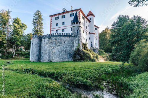 Famous 13th century Sneznik Castle (Grad Snežnik, Schloß Schneeberg), Slovenia. State castle Sneznik reflecting in a beautiful pond. Loška Dolina, Slovenia.