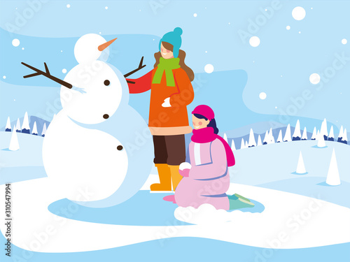 women with snowman in winter landscape