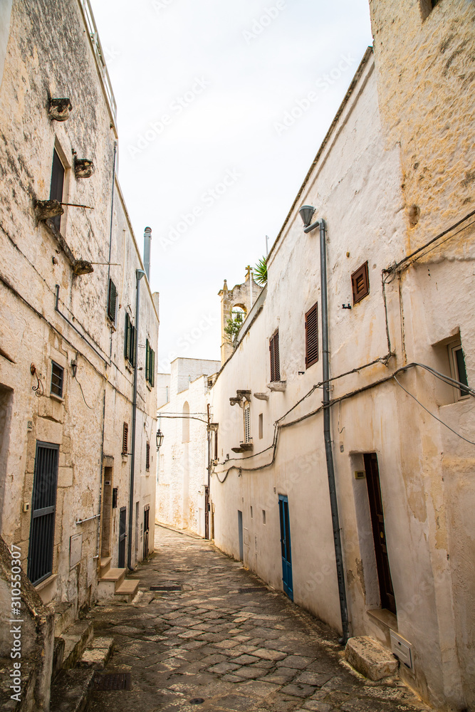 A public street with traditional houses in the old town area of the city center in Ostuni, South Italy