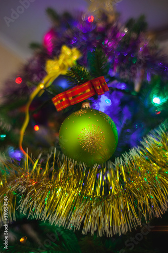 Christmas tree with toys and decorations and lights.