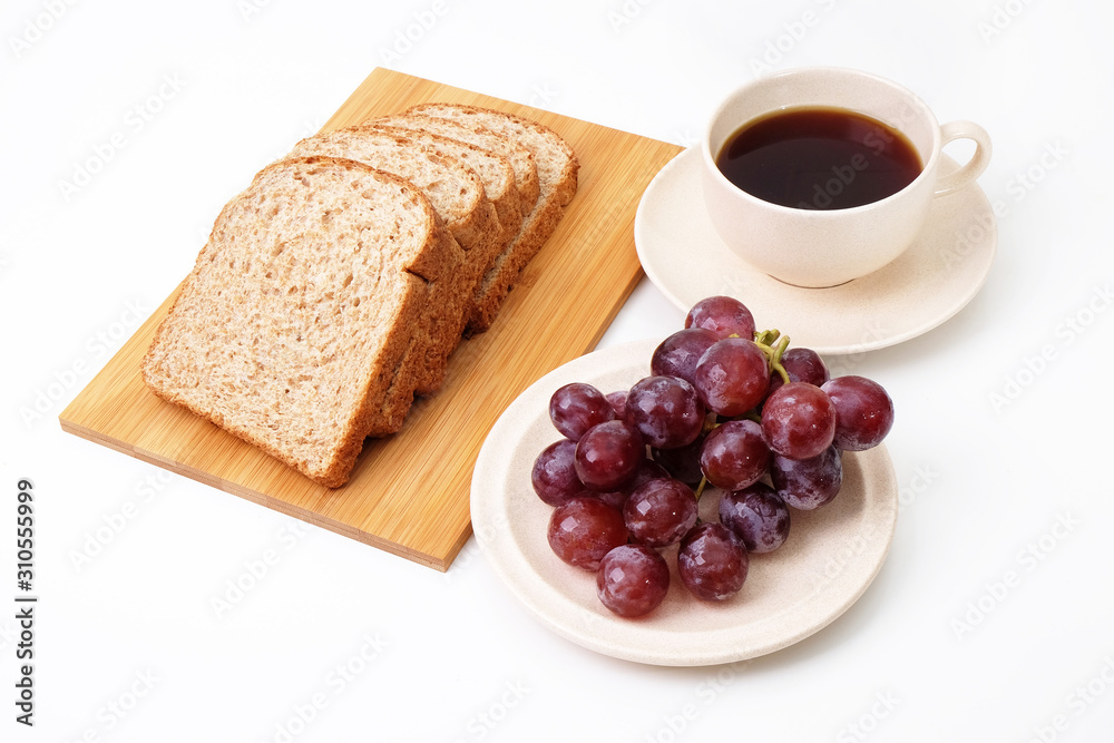 Whole grain bread and grapes serve with a cup of coffee..