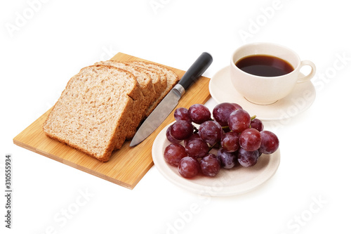 Whole grain bread and grapes serve with a cup of coffee isolated on white background..