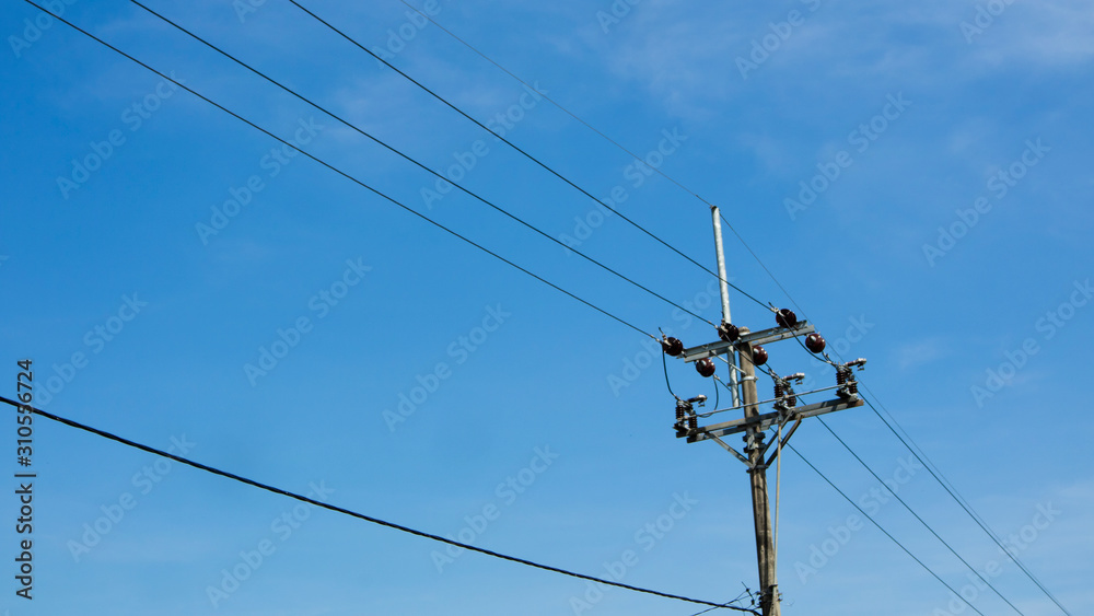 Electric poles against a cloudy blue sky background. Spring has come Electric poles against a cloudy blue sky background. Spring has come