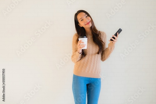 Portrait beautiful young asian women smile happy use mobile smart phone