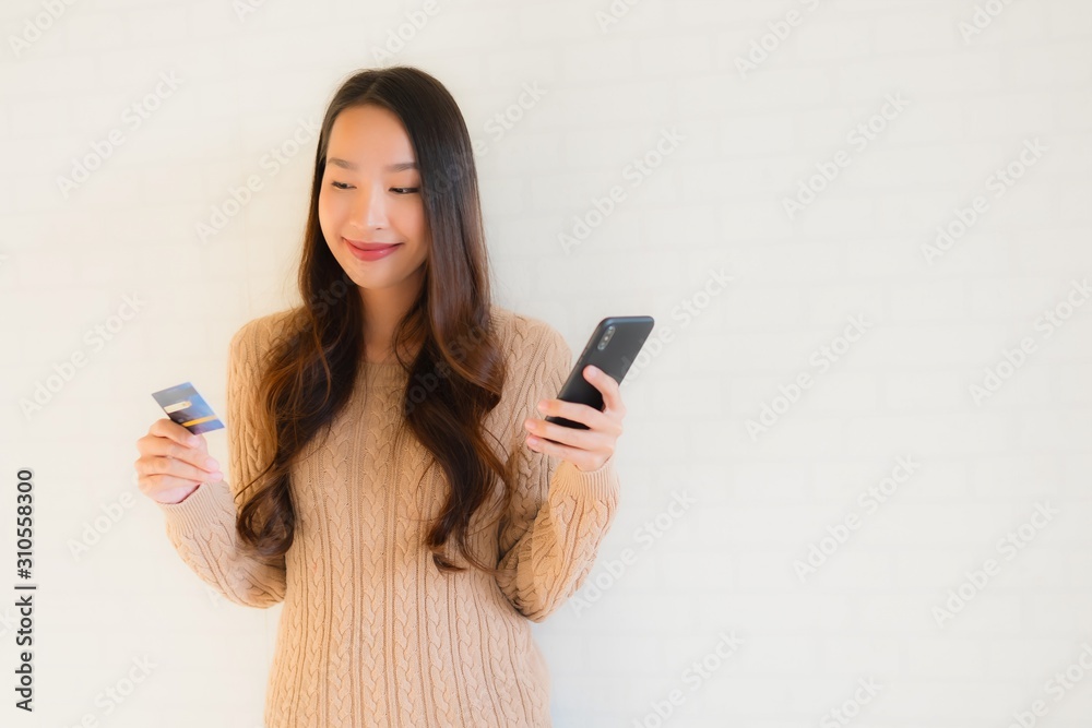 Portrait beautiful young asian use mobile smart phone with credit card Portrait beautiful young asian use mobile smart phone with credit card