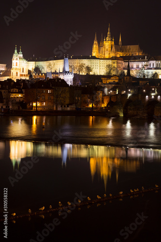 Night winter Prague Lesser Town with the gothic Castle and Charles Bridge above the River Vltava, Czech Republic © Kajano