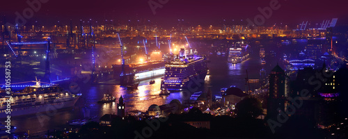 Hamburg, Germany: 3 large cruise ships leaving Hamburg during Hamburg Cruise Days 2015. The Hamburg harbour is at this point in time illuminated by blue light. Picture taken from St. Michaelis church.