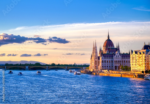 The Hungarian Parliament Building located on the Danube River in Budapest Hungary at sunset.