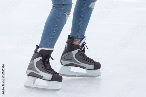 legs of a skating man on an ice rink
