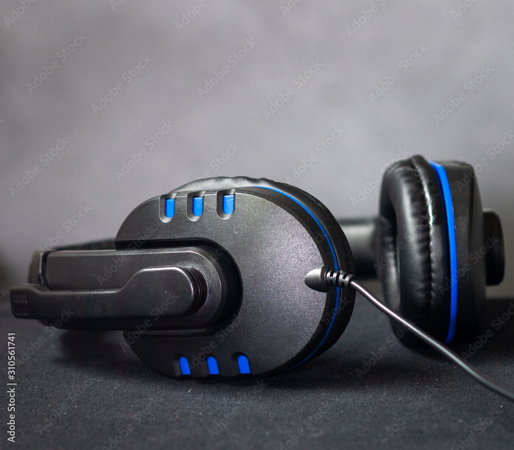 black and blue earphone, Game play and music. - obrazy, fototapety, plakaty 