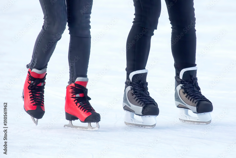 different people are actively skating on an ice rink different people are actively skating on an ice rink