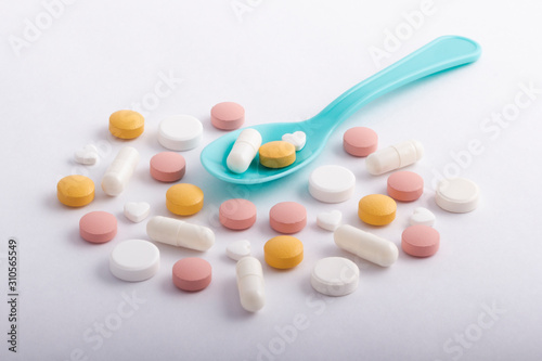 Spoon with medicines on a white background. Medicine concept.