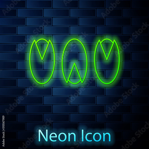 Glowing neon line Pistachio nuts icon isolated on brick wall background. Vector Illustration