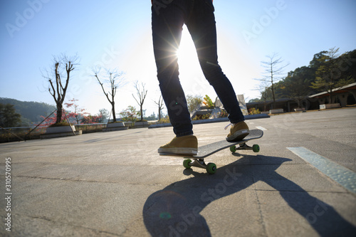 Skateboarder skateboarding at sunrise city