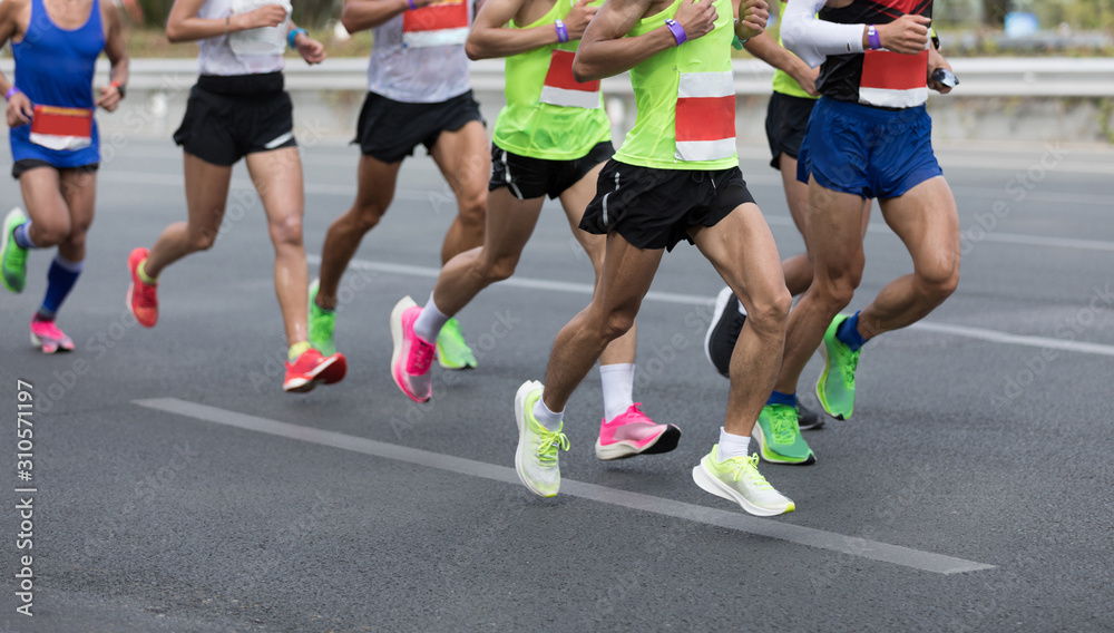 Marathon runners running on the race on city road Marathon runners running on the race on city road