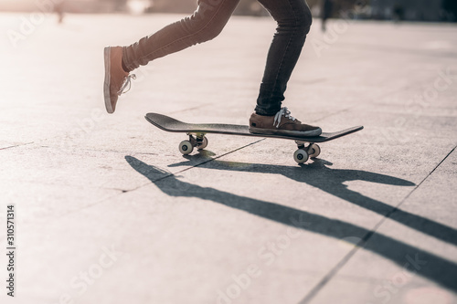 Skateboarder skateboarding at sunset city