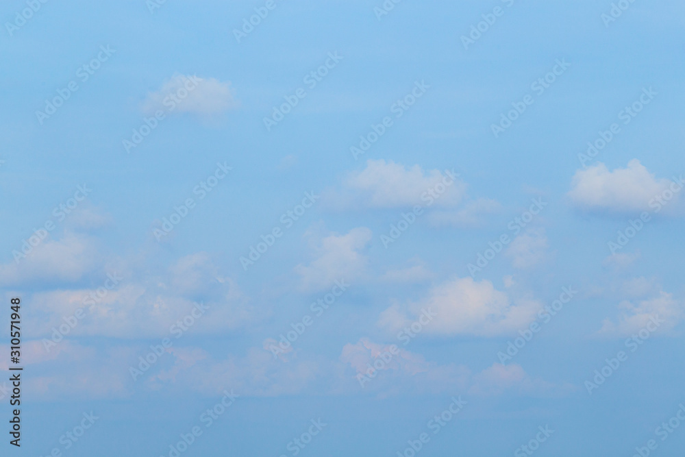 Floating clouds, fluffy colors against the blue sky