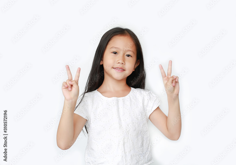 Smiling little kid girl showing two finger gesture as sign as fighting isolated over white background. Smiling little kid girl showing two finger gesture as sign as fighting isolated over white background.