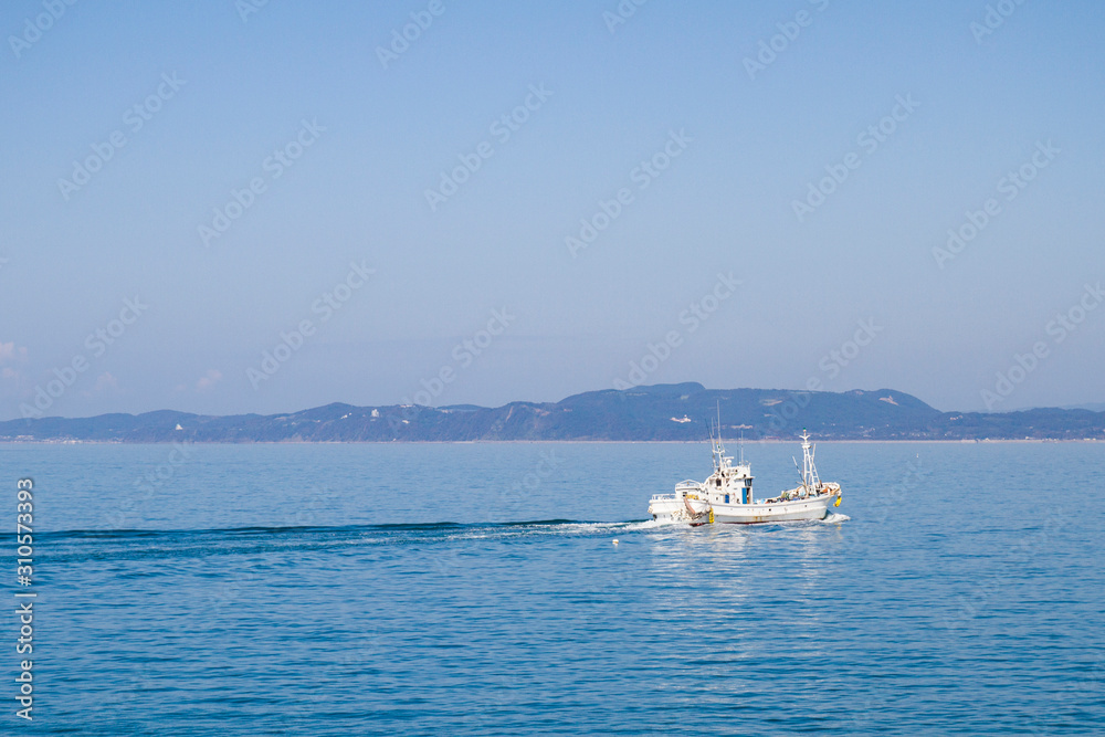 fishingboat sail in blue sea