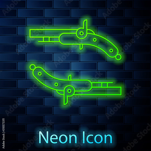 Glowing neon line Vintage pistols icon isolated on brick wall background. Ancient weapon. Vector Illustration