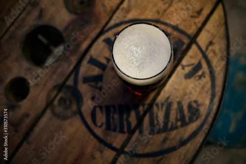 Cold beer on the bars wooden table photo